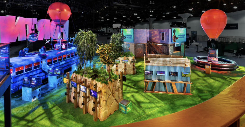 E-3 convention of Epic Game's Fortnite in 2018. Fake green grass, decorated booths, the battle bus, and more from inside the game's universe 